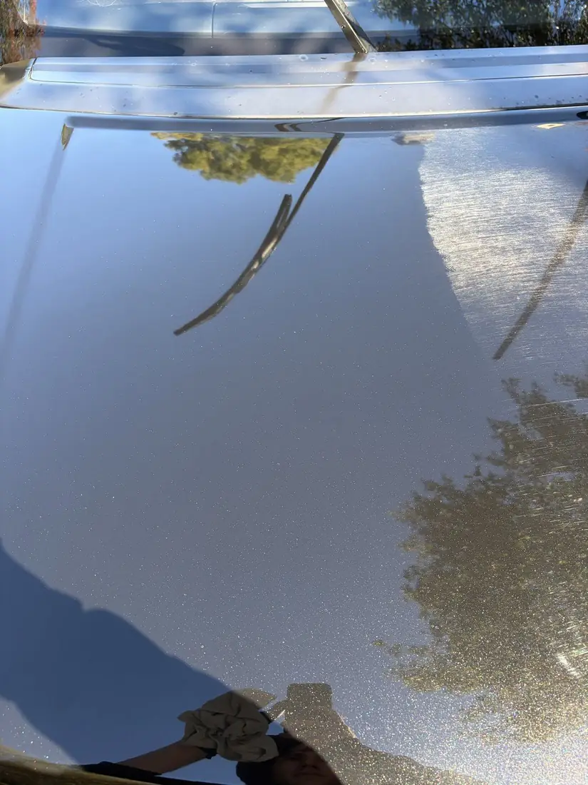 Range Rover hood 50/50: left half paint corrected, right half swirled
